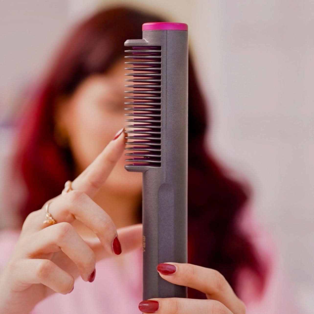 Person holding a hair straightener with a blurred background