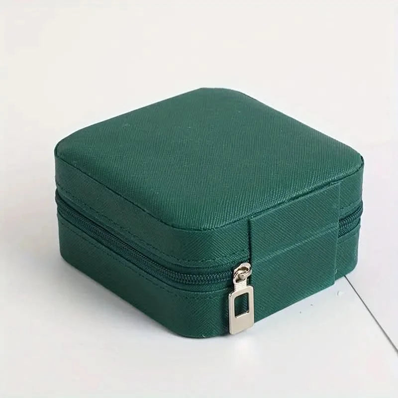 Green jewelry box with a gold zipper on a white background