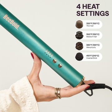 Teal hair straightener held by a hand with heat setting chart on a white background