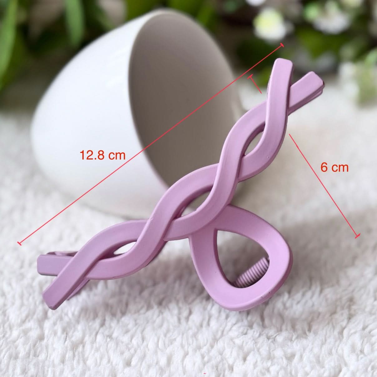 Purple hair clip with measurements on a white background