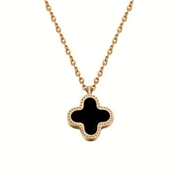 van cleef gold necklace with a black clover pendant on a white background