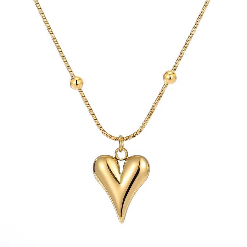 Gold heart-shaped pendant on a gold chain against a white background