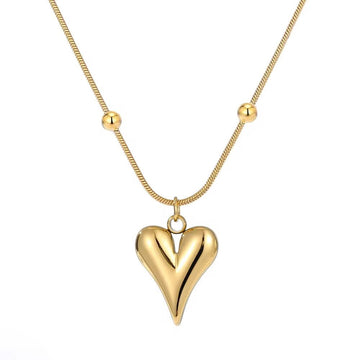 Gold heart-shaped pendant on a gold chain against a white background