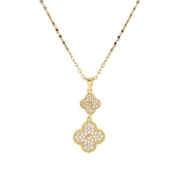 Gold necklace with a clover-shaped pendant on a white background