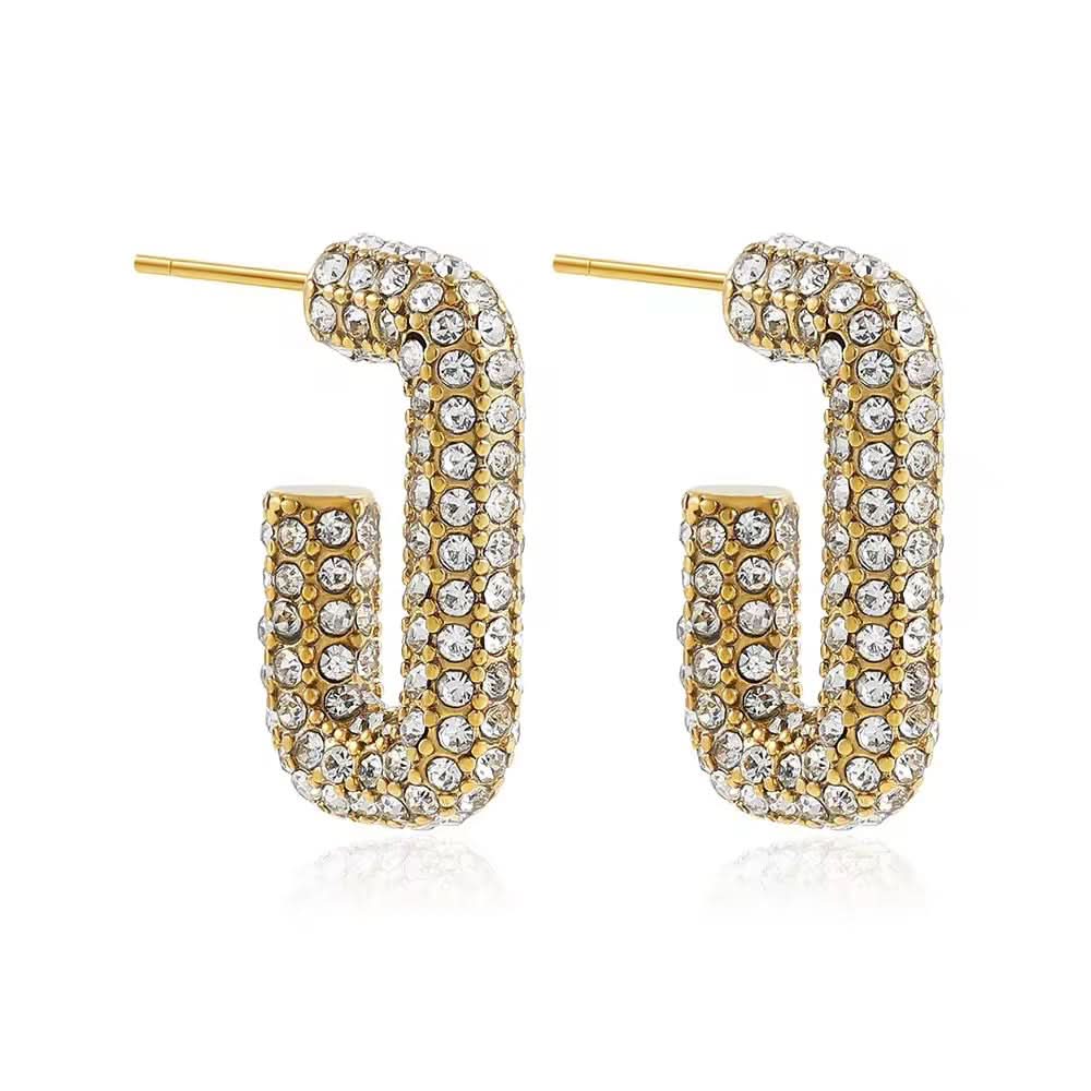 Gold and crystal hoop earrings on a white background