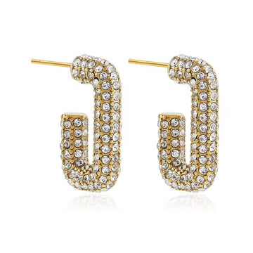 Gold and crystal hoop earrings on a white background