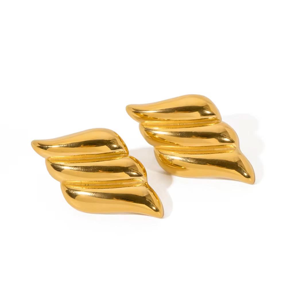 Pair of gold wing-shaped earrings on a white background