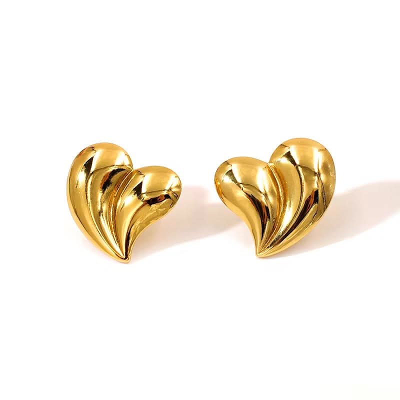 Gold heart-shaped earrings on a white background