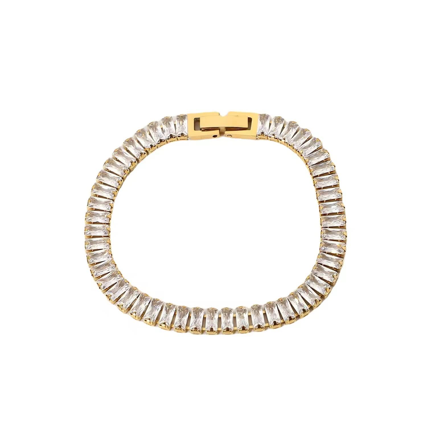 Gold bracelet with clear gemstones on a white background