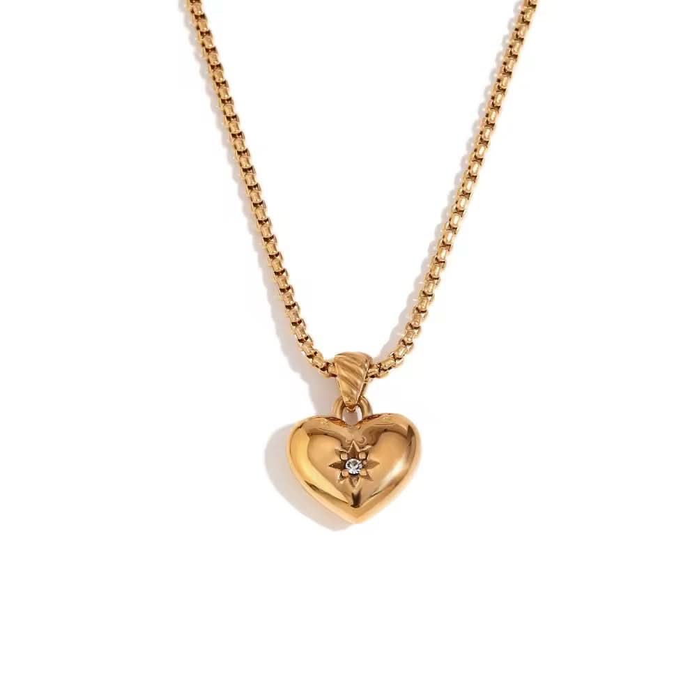 Gold heart-shaped pendant necklace on a white background
