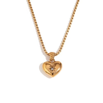 Gold heart-shaped pendant necklace on a white background