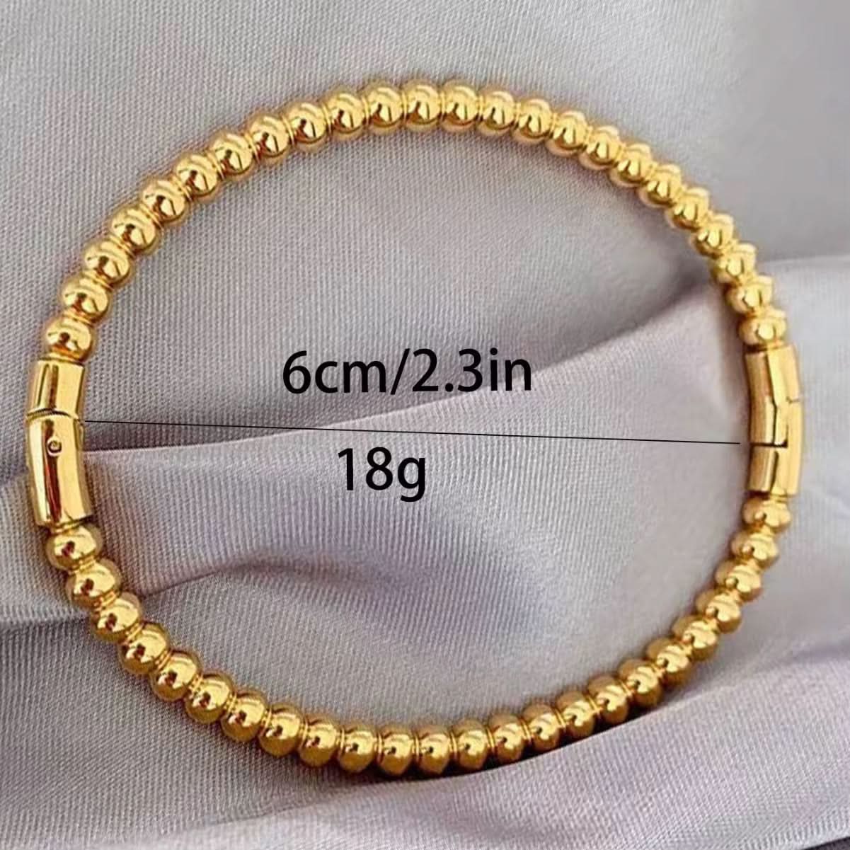 Gold beaded bracelet with measurements on a light gray background