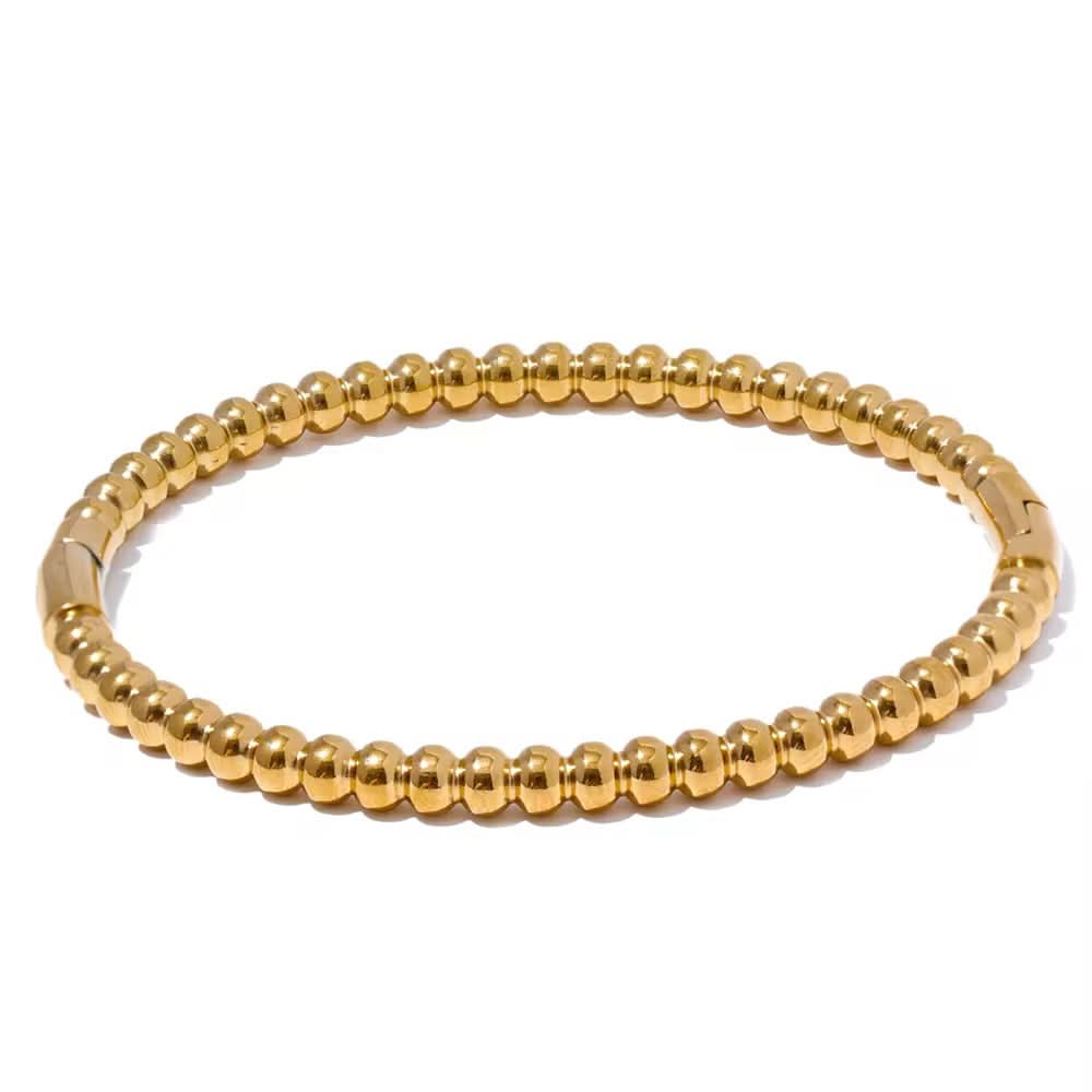 Gold beaded bracelet on a white background