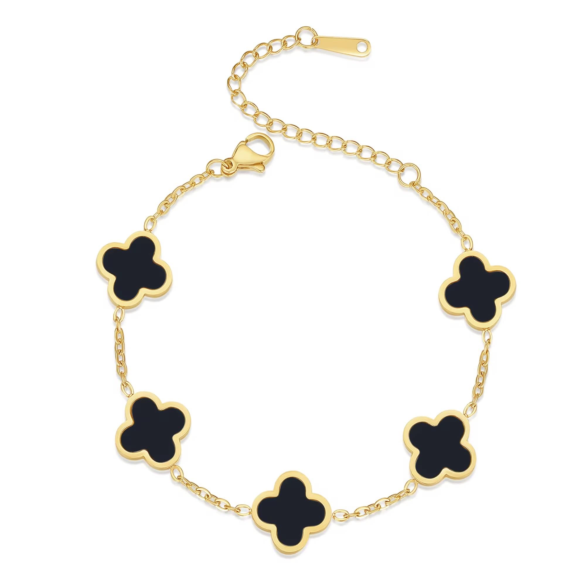 Gold bracelet with black clover-shaped charms on a white background