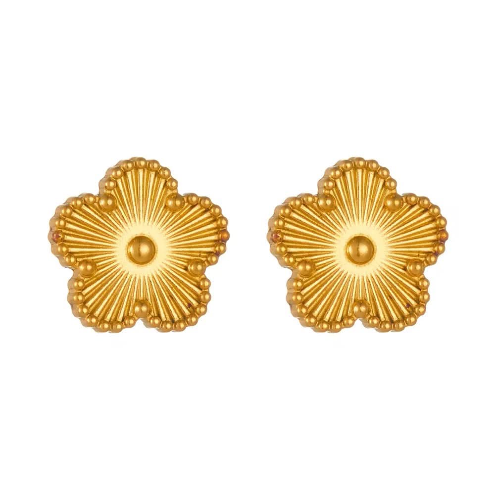 Pair of gold flower-shaped earrings on a white background