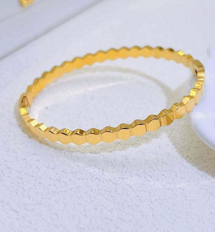 Gold bracelet on a white background